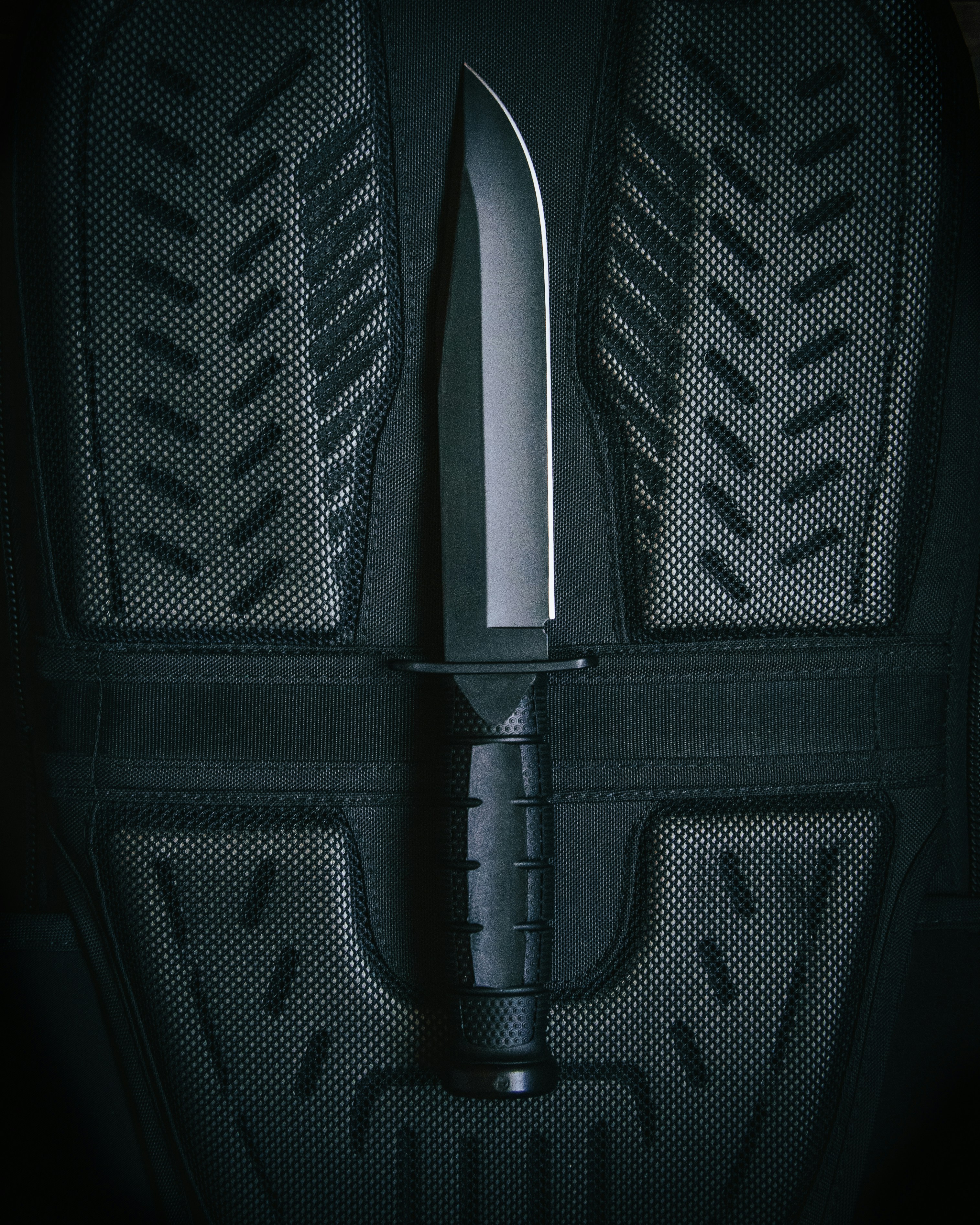 black and gray backpack on black textile