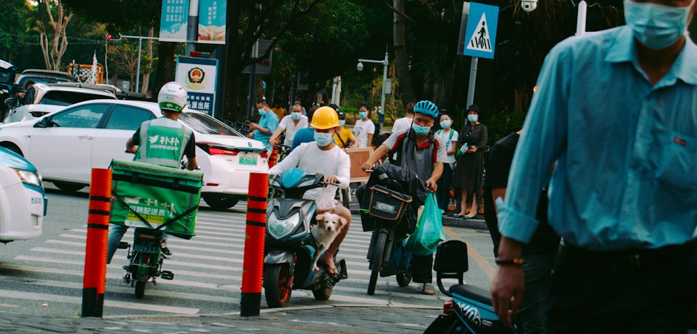 people riding on motorcycle on road during daytime