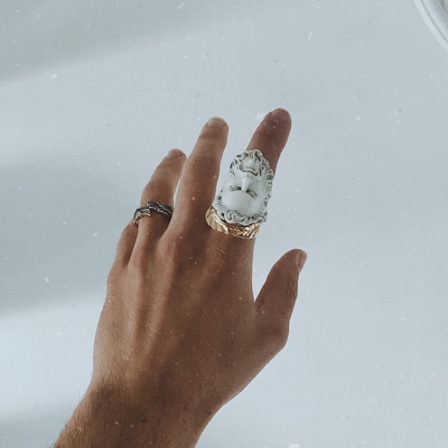 silver and diamond ring on persons finger