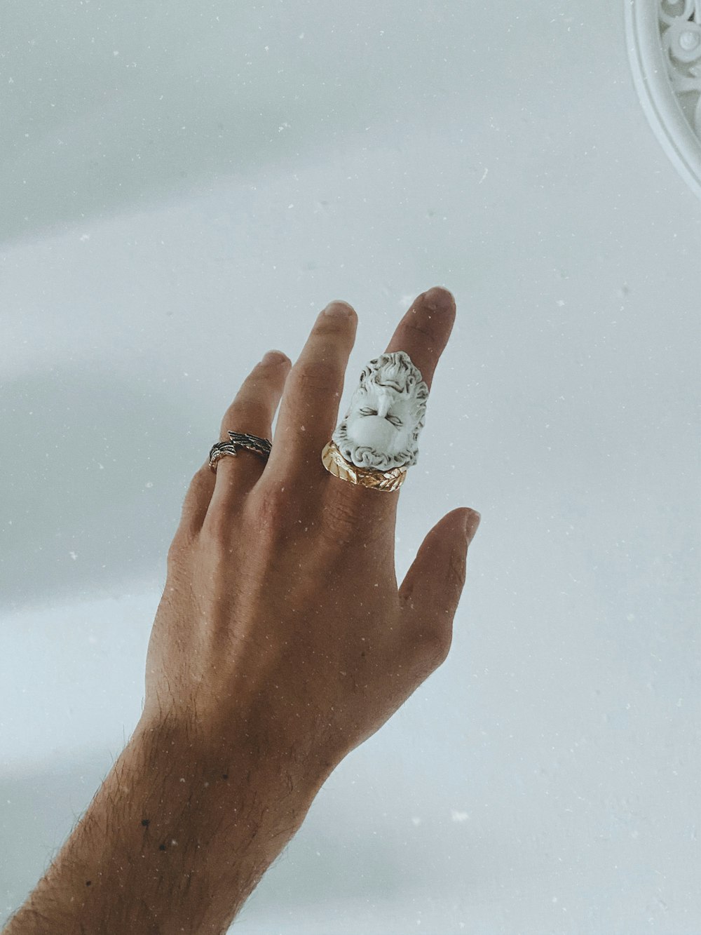 silver and diamond ring on persons finger