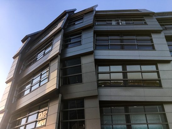 Modern office building with dark tones and sleek architectural lines.