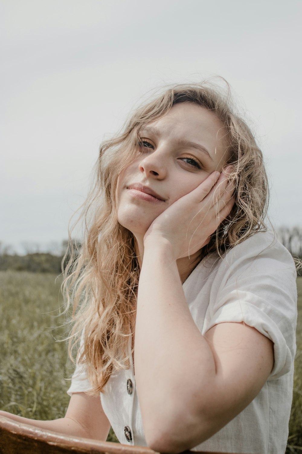 woman in white shirt lying on green grass field