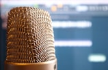 A close-up of a microphone in a radio studio.