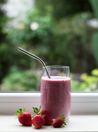 clear drinking glass with red liquid