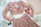 Close-up of delicate embroidery on a beige co-ord set with soft pastel accents.