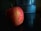 A close-up of a vibrant apple resting on a wooden table.