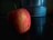 A close-up of a vibrant apple resting on a wooden table.