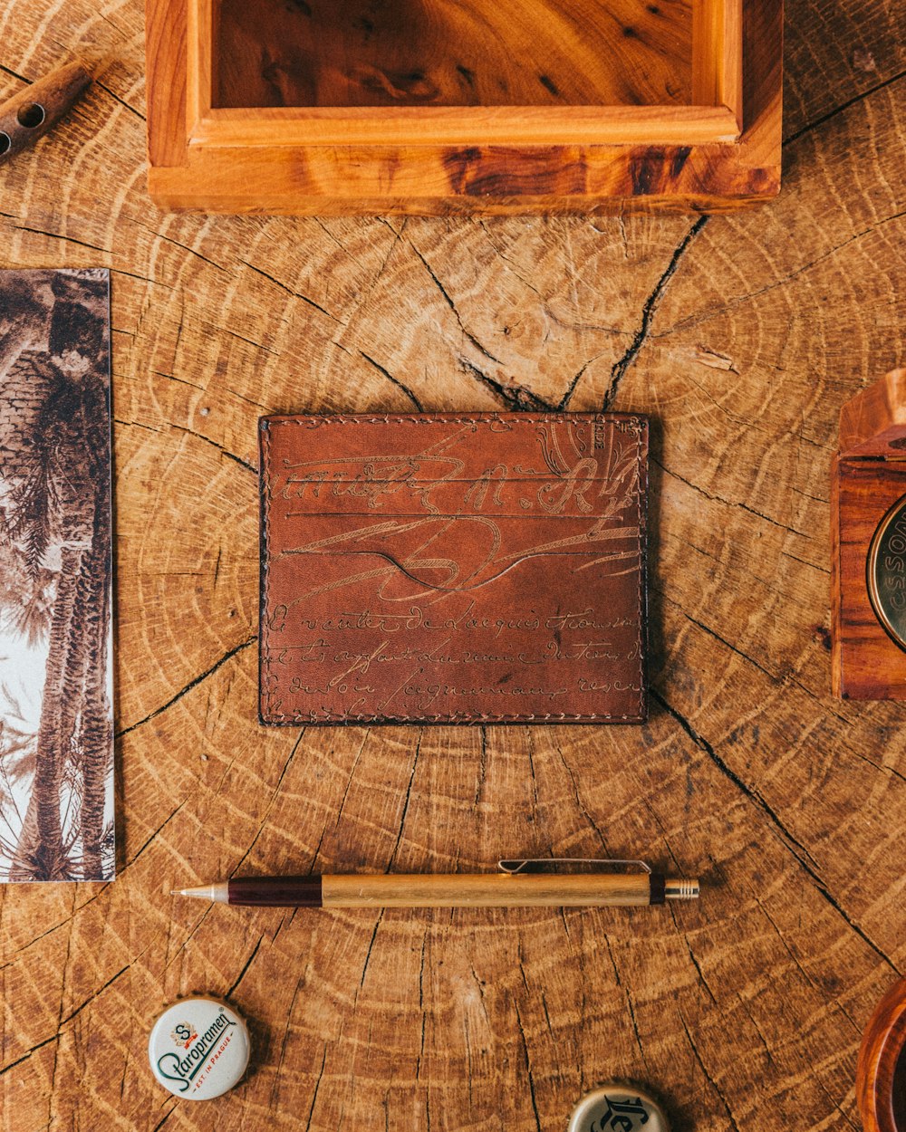 brown wooden board beside black and white pen