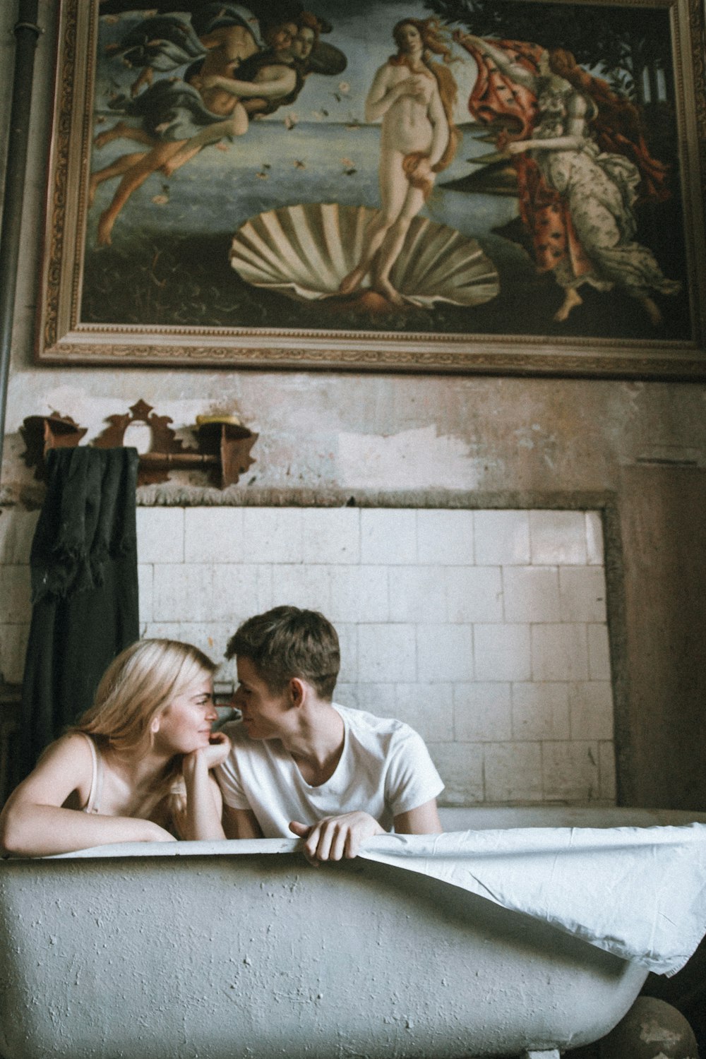 a man and a woman sitting in a bathtub