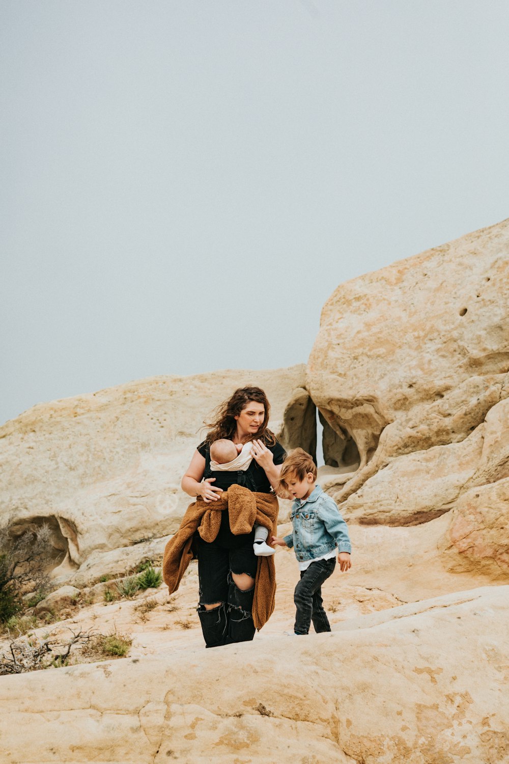 man and woman standing on brown rock formation during daytime