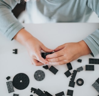 person in white long sleeve shirt holding black and white dices