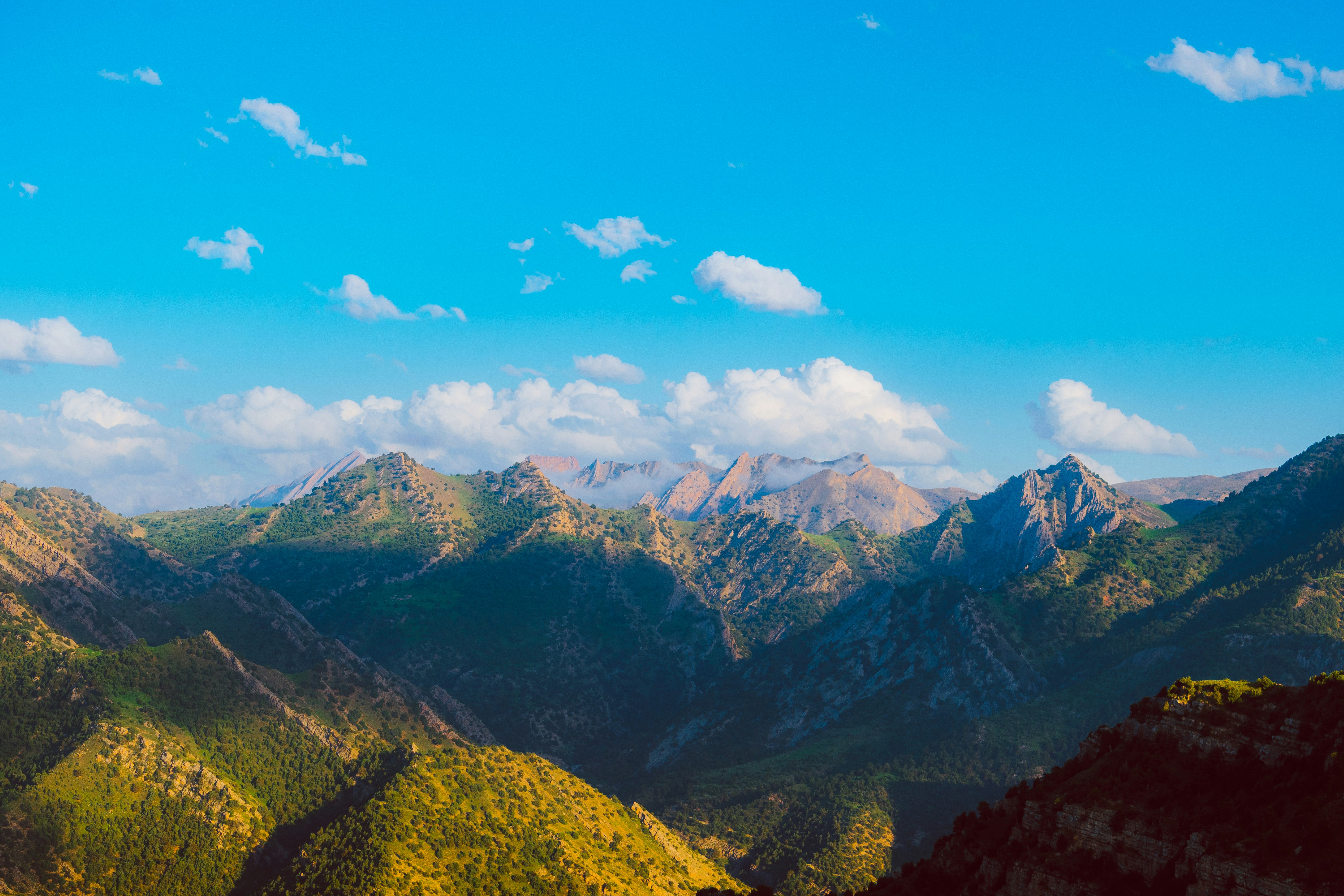 green and brown mountains under blue sky during daytime