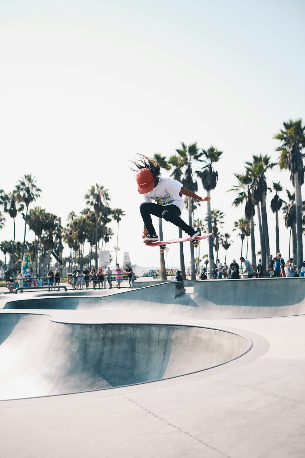 man in black t-shirt and black pants doing skateboard stunts on skateboard ramp during daytime