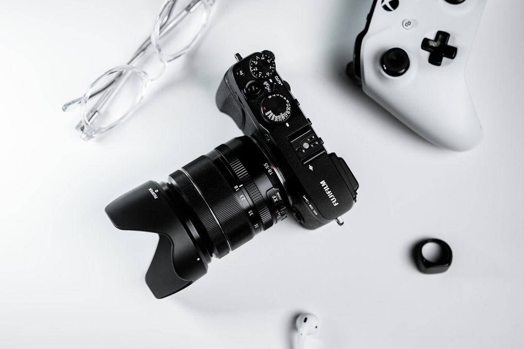 black nikon dslr camera on white surface,