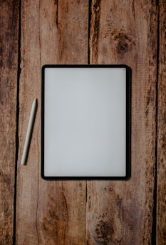 white and black board on brown wooden surface
