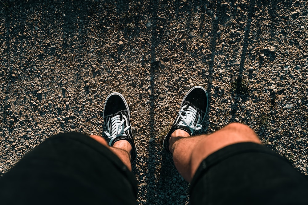 person wearing black and white sneakers