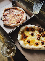 Half-metre pizza box open, revealing a large, steaming hot pizza inside, highlighting heat retention.