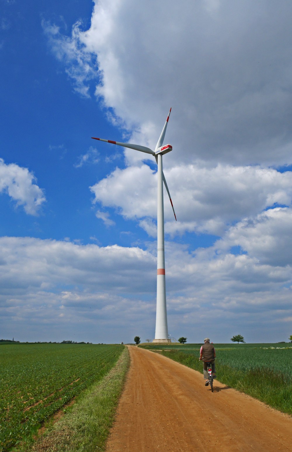 white and red windmill under blue sky during daytime