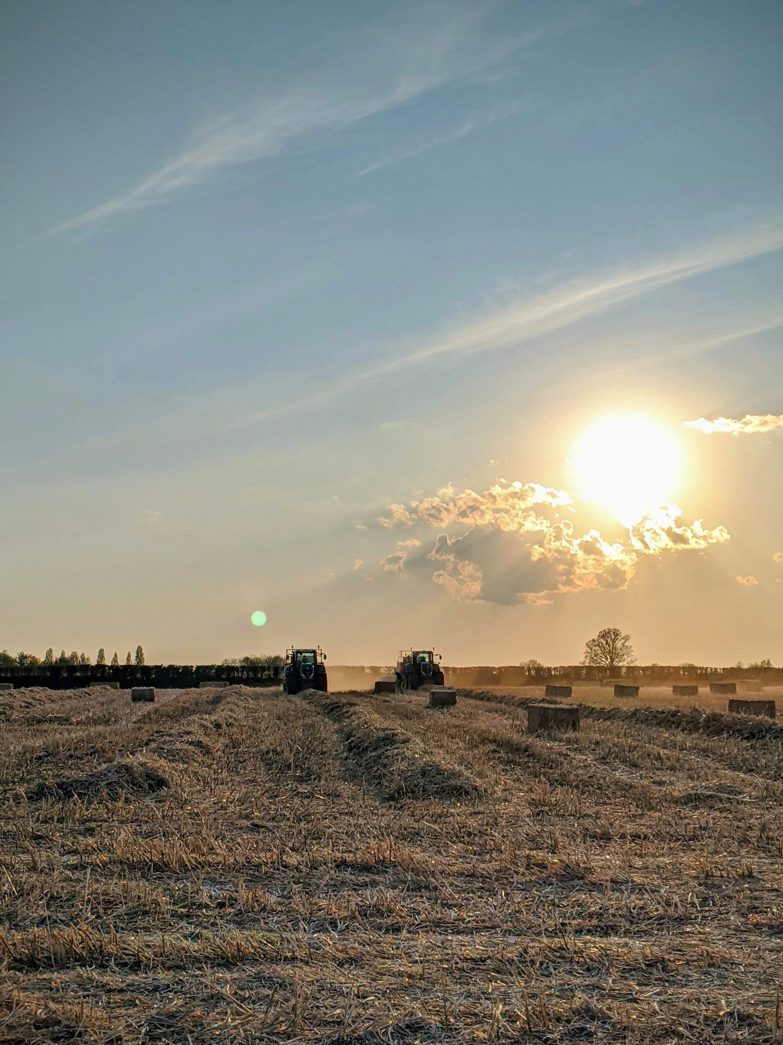 Tractor plowing a field during sunset