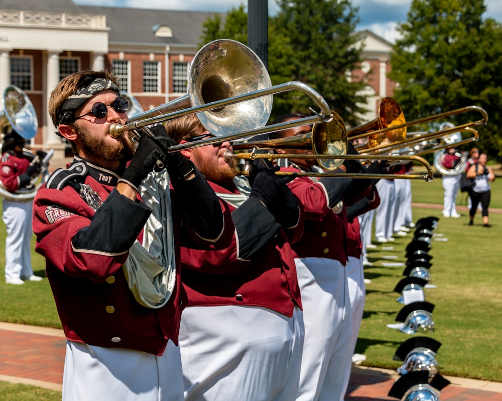 man in white and red uniform playing trumpet