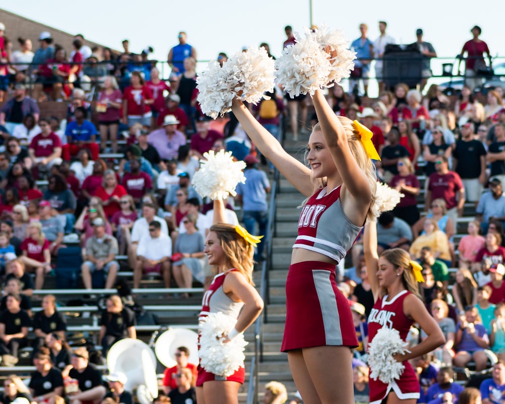 women in white and red uniform dancing on stage during daytime