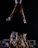 A cheerleader performing a stunt during a competition.