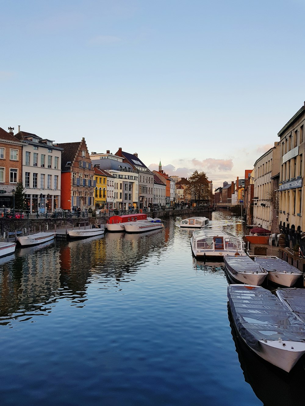 boat on river between buildings during daytime