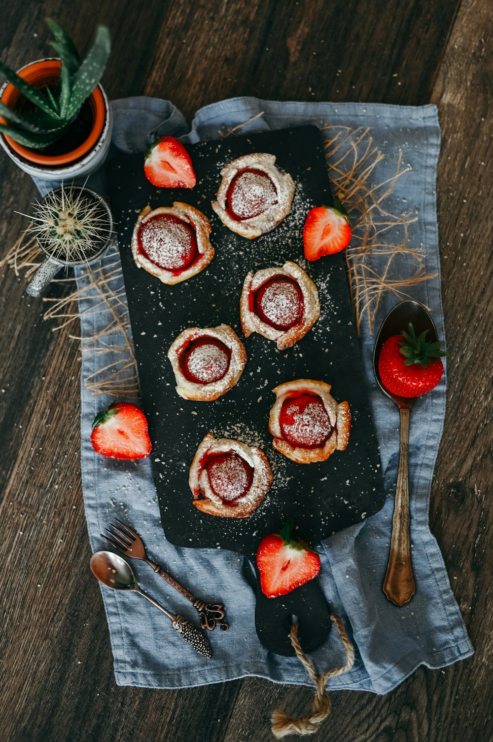 brown and white donuts on black tray