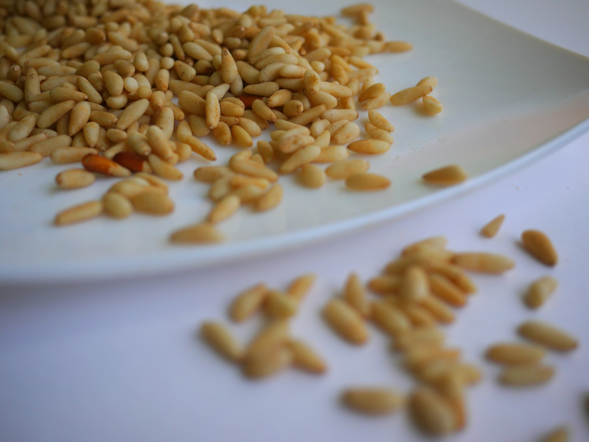 brown peanuts on white ceramic plate