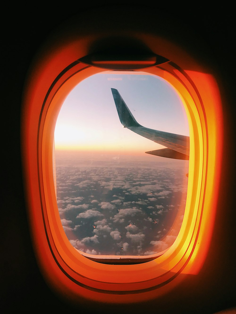 airplane window view of clouds during daytime