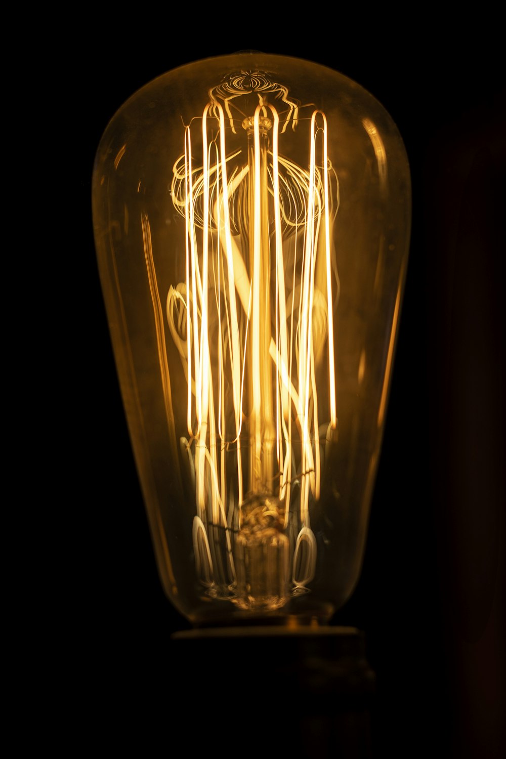 clear glass light bulb with black background