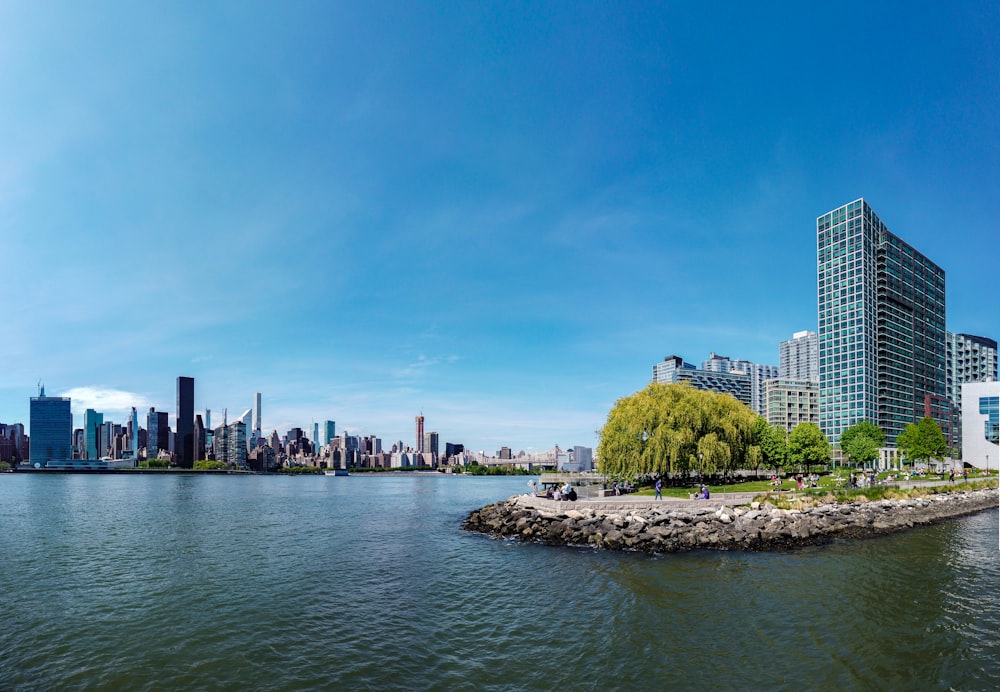 people on beach near city buildings during daytime