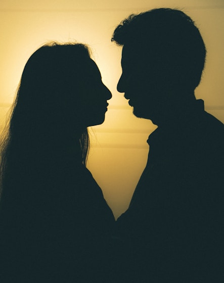 silhouette of man and woman kissing