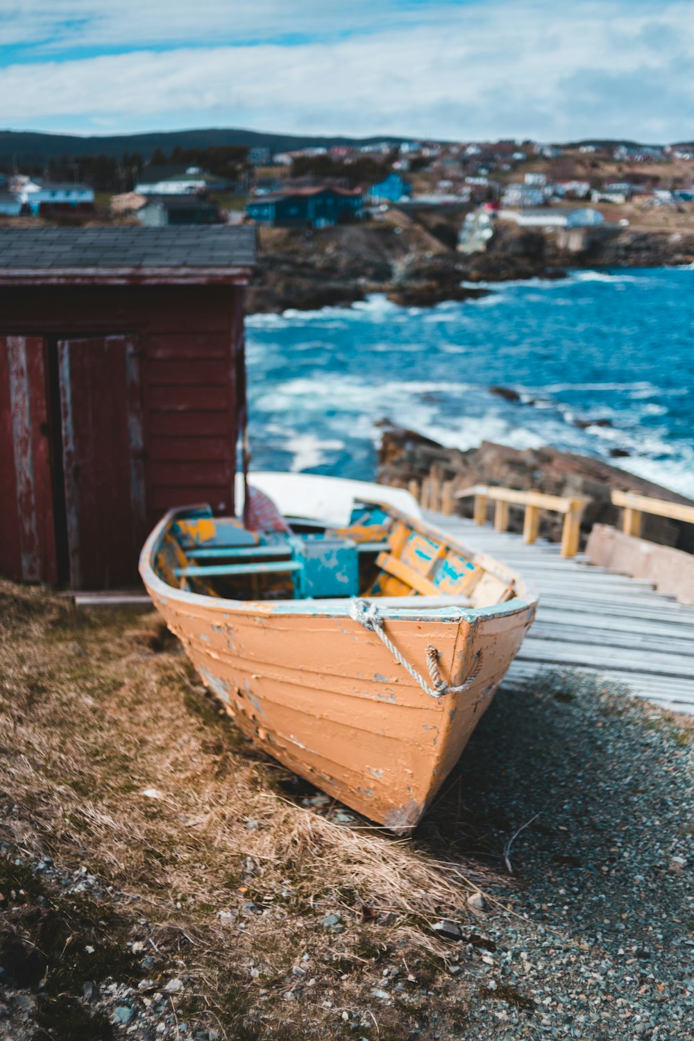 brown and white boat on seashore during daytime