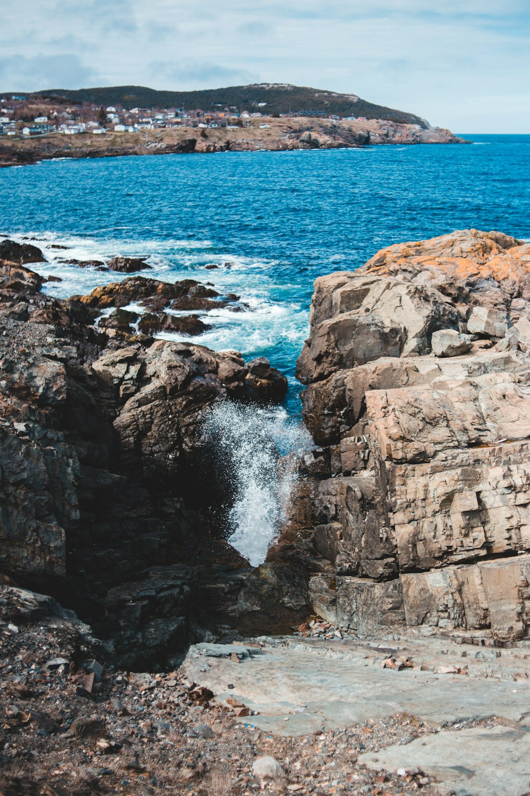 brown rock formation beside body of water during daytime