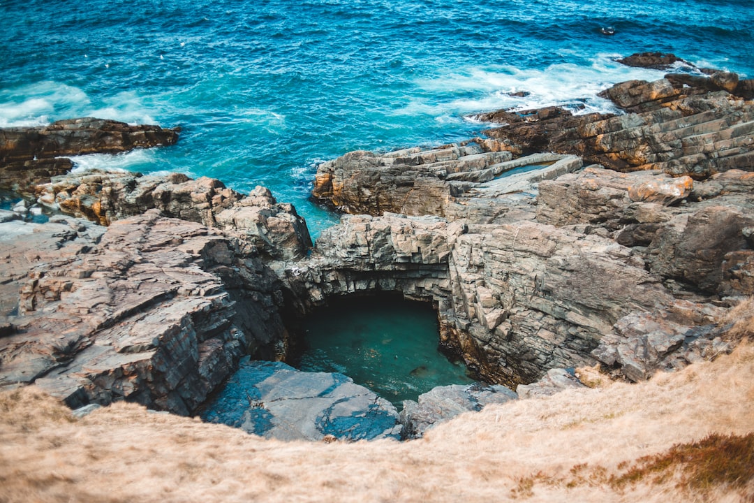 brown rock formation beside blue sea during daytime