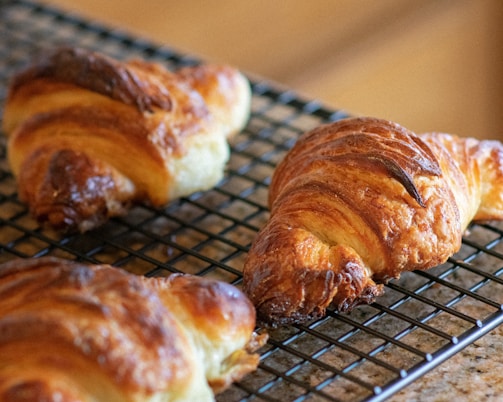A warm, golden-brown pastry fresh out of the oven on a cooling rack.
