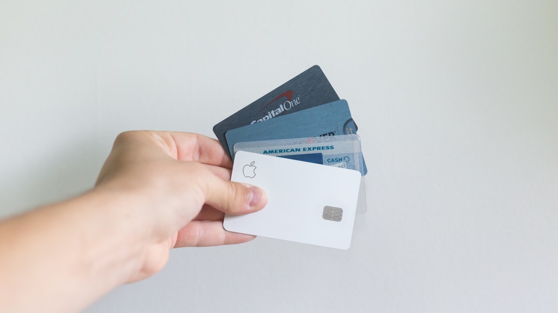 A credit card held in a hand, representing the chargeback route shoppers take when a brand refuses a return