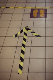 Interior warehouse floor with bold yellow safety lines and directional arrows.