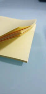 Soft beige sticky notes with handwritten notes and subtle shadows.