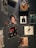 A wall decorated with various framed album covers and autographed photographs. There is a dark wall partially covered with images of musicians and singers. Some frames contain vintage album artworks while others feature black and white portraits with handwritten notes.