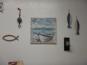 3D printed framed artwork with marine motifs hanging on a light blue wall.
