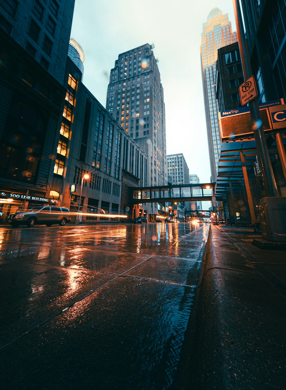 people walking on sidewalk near high rise buildings during daytime