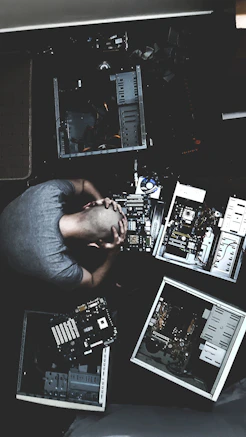 man in blue shirt using computer