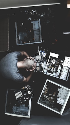 man in blue shirt using computer