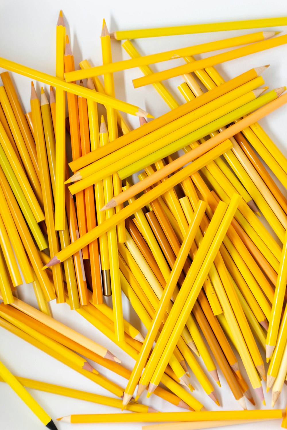 yellow pencils on white surface