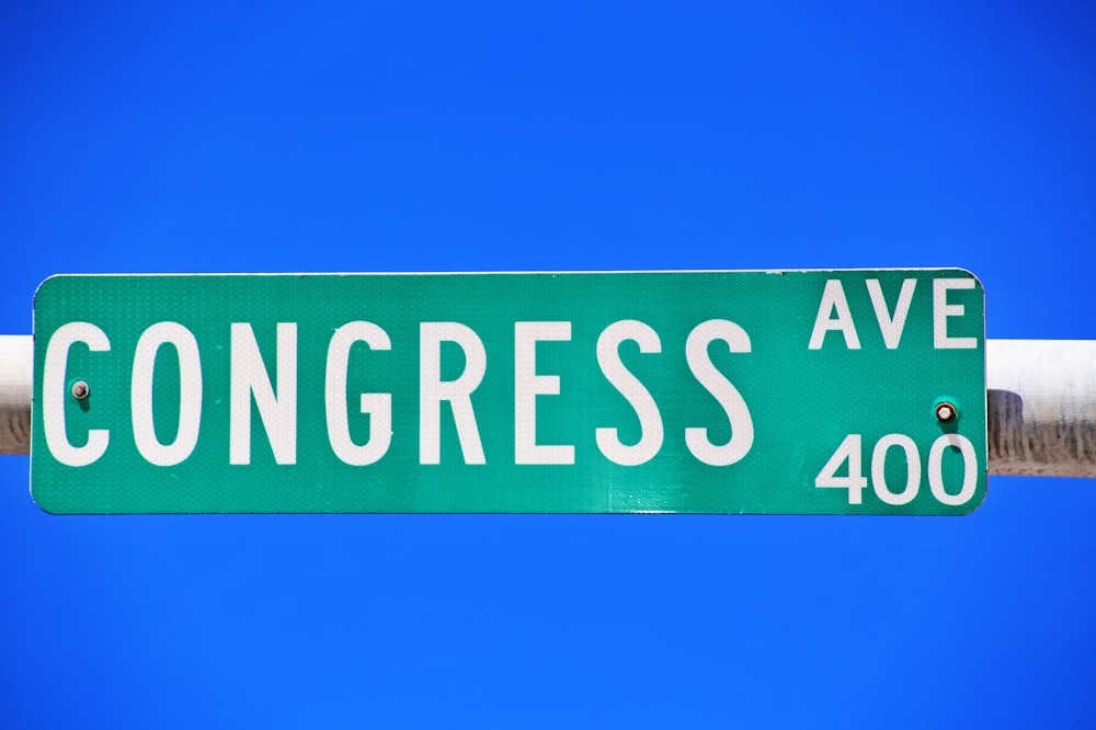 a close up of a street sign with a sky background