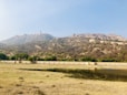 green grass field near mountain during daytime