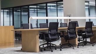 black office rolling chair beside brown wooden desk