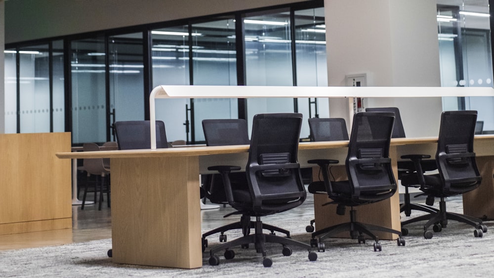 black office rolling chair beside brown wooden desk